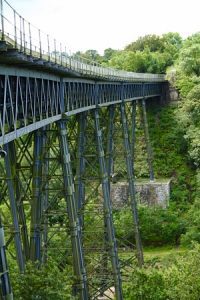 Green metal bridge located at the Granite Way in Dartmoor, UK